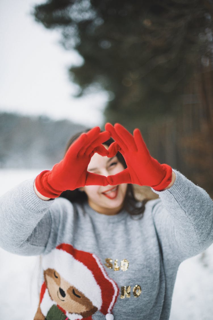 Smiling Woman Making Hand Heart Outdoors