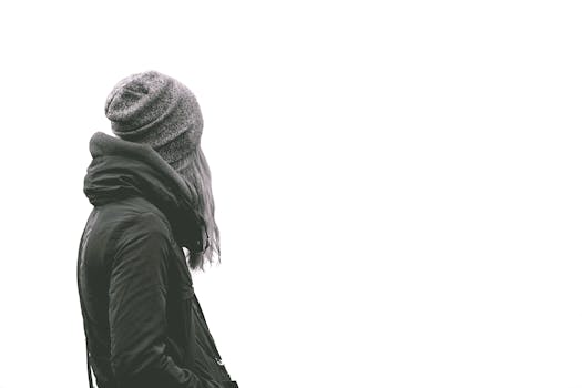 一位身着冬季夹克和无斜纹棉呢的女人，面朝普通背景