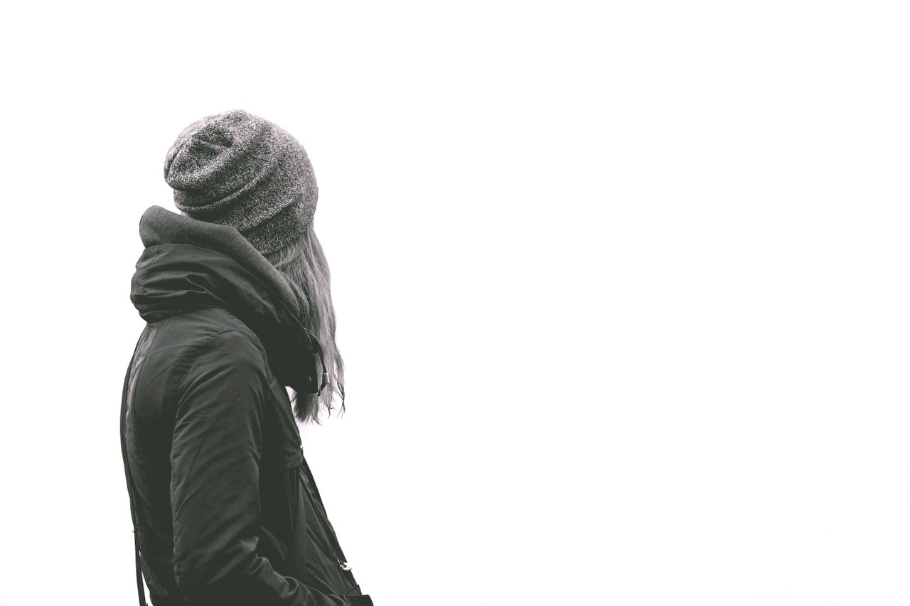 Back view of a woman wearing a knit cap with her hair tucked underneath