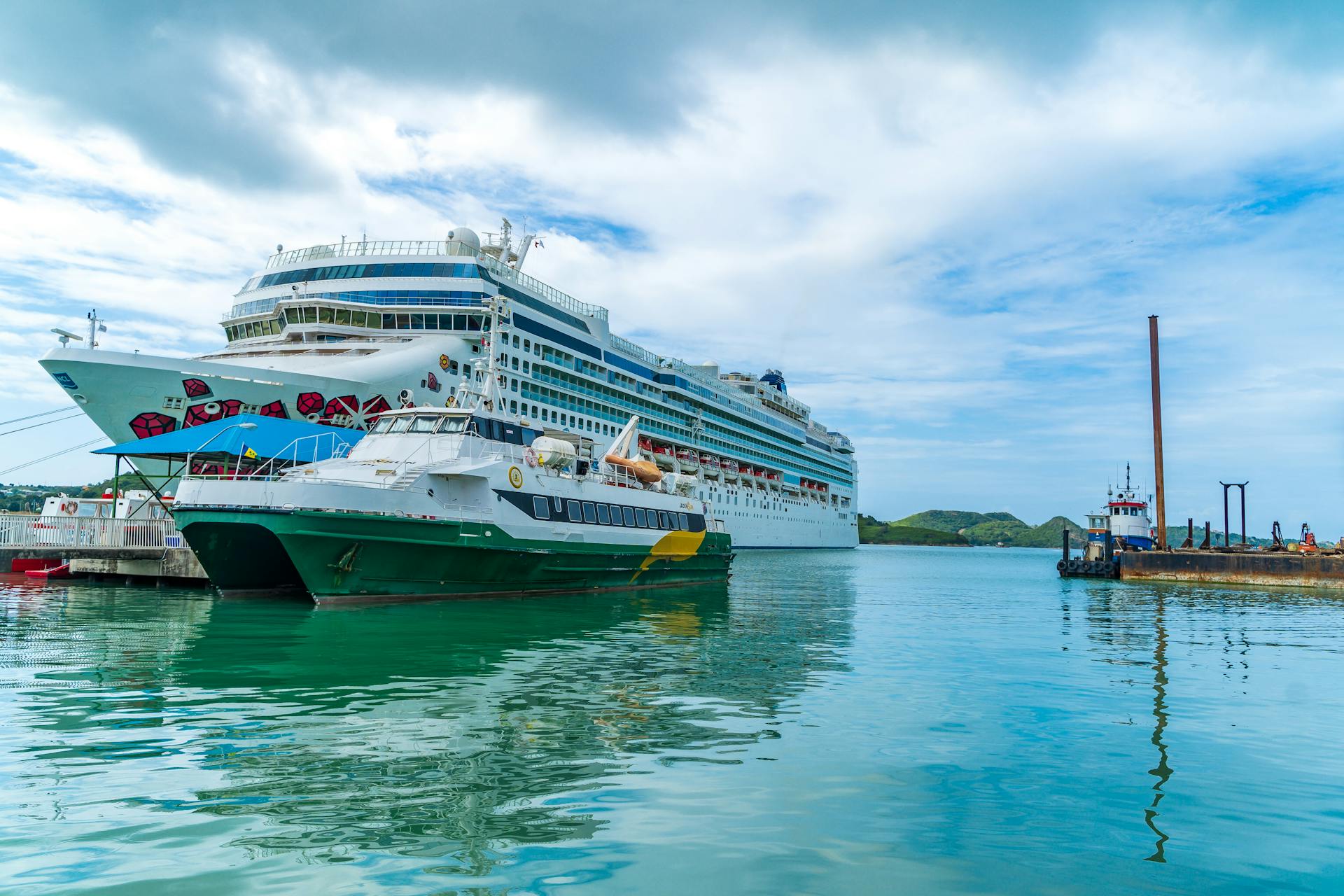 Vibrant cruise ships docked in the scenic harbor of Antigua, a popular Caribbean destination.