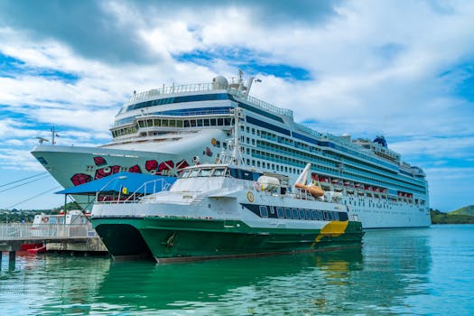 Scenic view of a cruise ship and ferry docked in Antigua's turquoise waters under a blue sky.