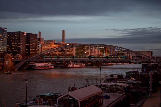 A picturesque view of a bridge over the Seine in Paris during evening twilight.