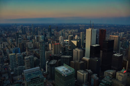 Breathtaking aerial view of Toronto's skyline at dusk, showcasing iconic skyscrapers.