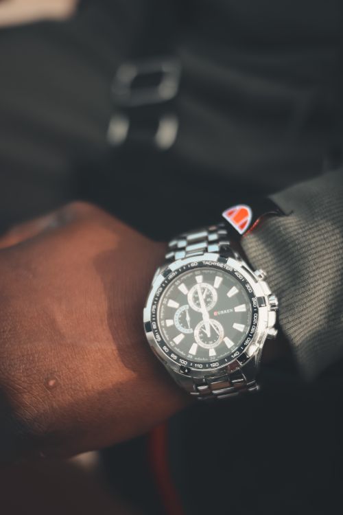 Free Elegant silver wristwatch with a chronograph feature on a wrist in a vertical composition. Stock Photo