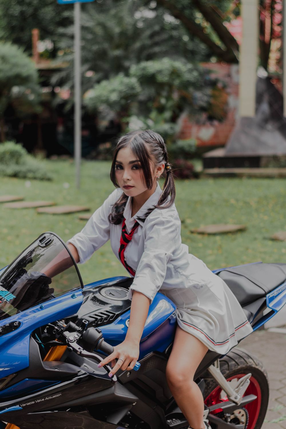 Woman Riding a Blue Motorcycle · Free Stock Photo