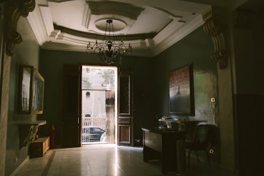 Sunlit interior featuring classic architectural details and a vintage chandelier