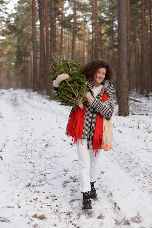 Woman in Red Scarf Holding Green Plant