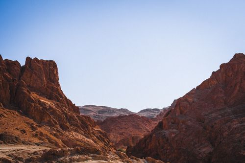 Free Beautiful desert scene featuring eroded red rock formations under a clear blue sky. Stock Photo