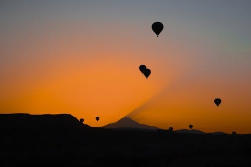 
A Silhouette of Hot Air Balloons during the Golden Hour
