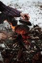 Person Holding Black Cooking Pan on Fire