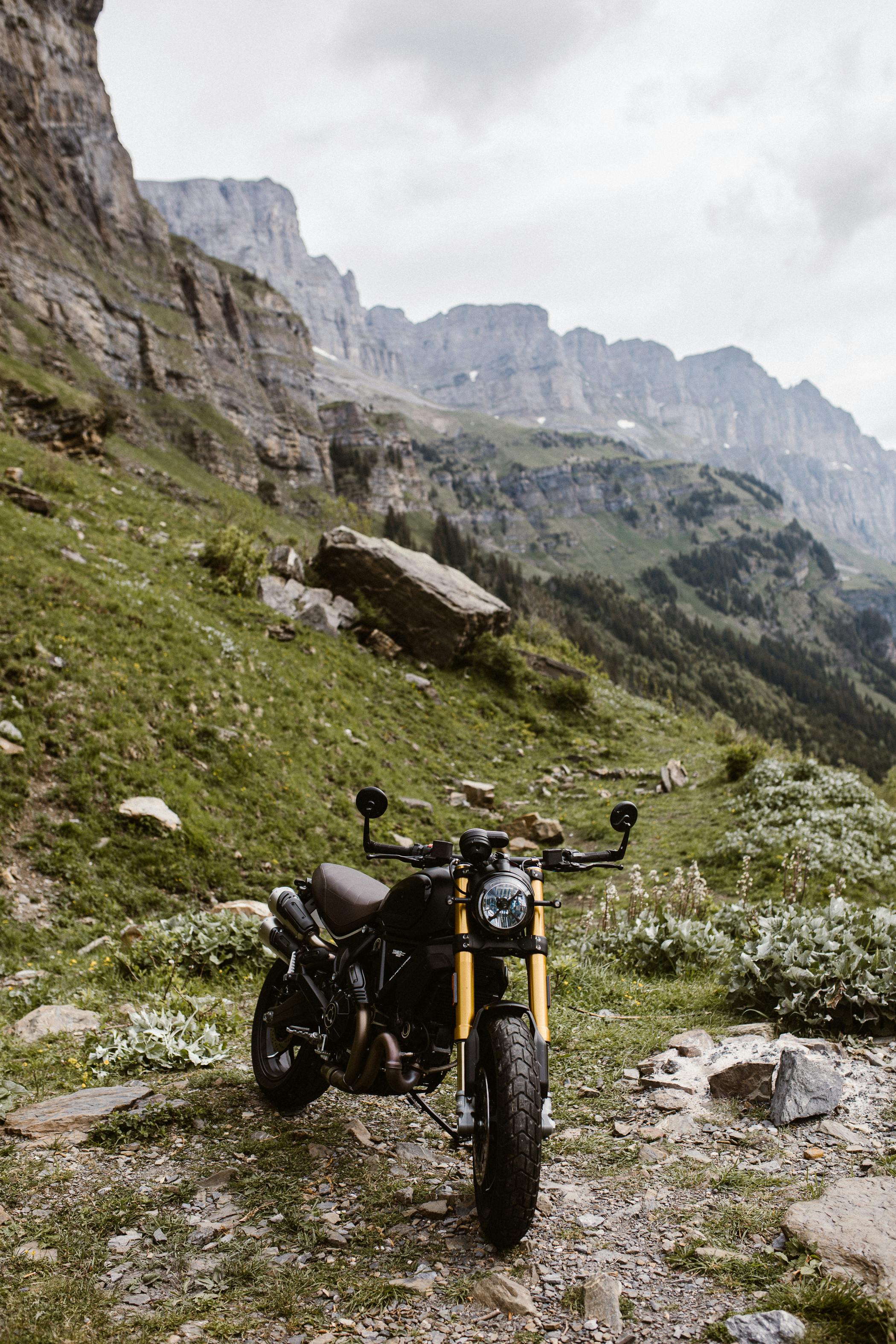 A Ducati motorbike parked in a scenic mountain landscape, ideal for adventure imagery.