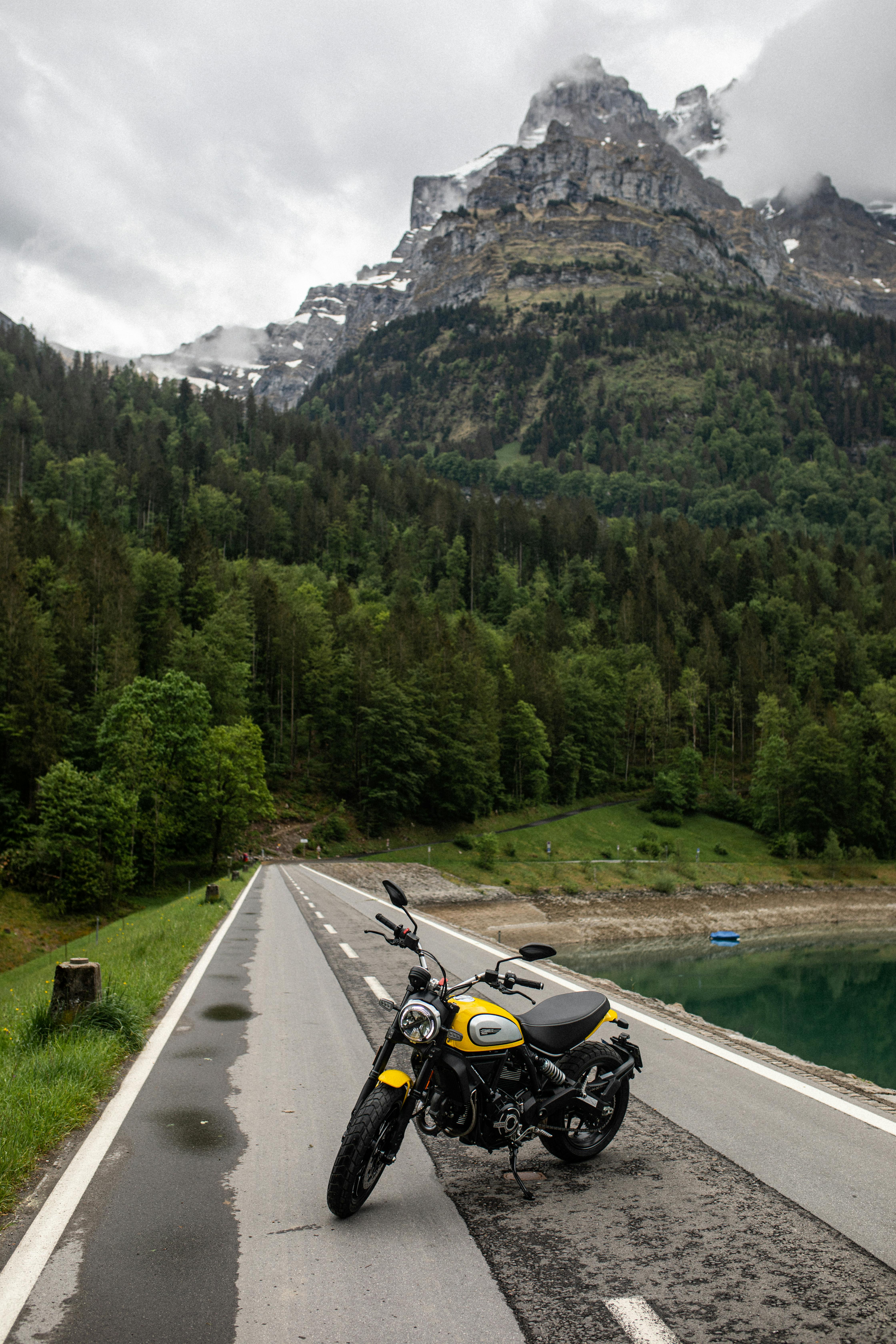 a ducati scrambler motorbike parked on road