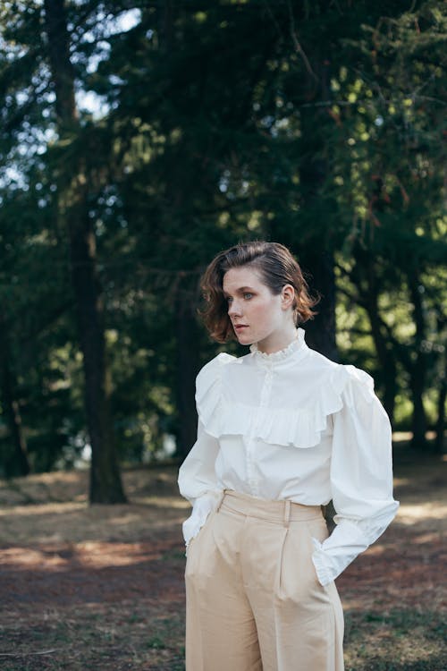 Young Woman Wearing Old-Fashioned Shirt Standing in Park