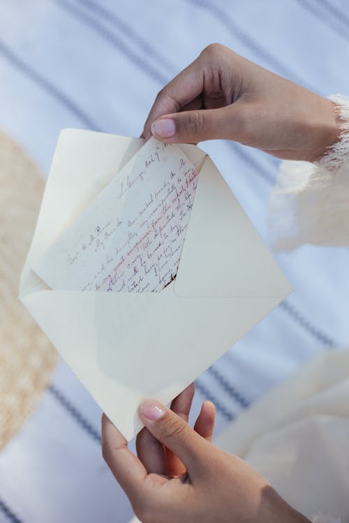 Close-up of Womans Hands Holding Letter