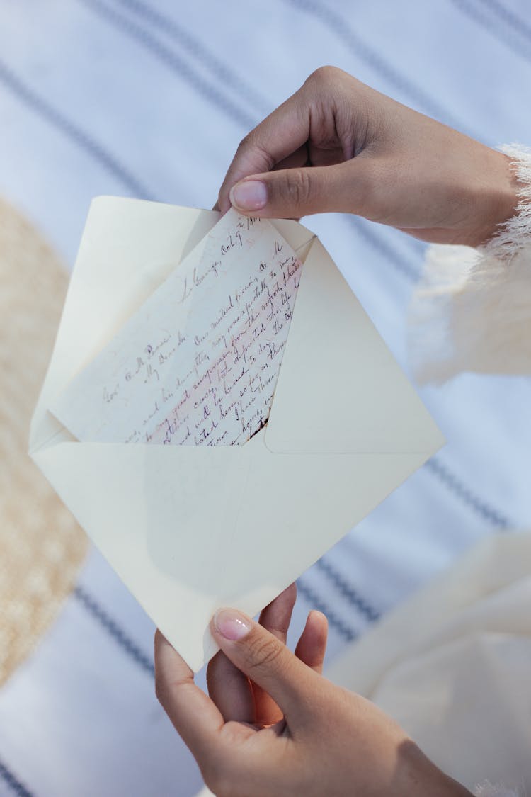 Close-up Of Womans Hands Holding Letter