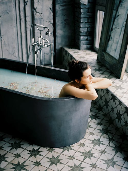 Free Woman Sitting in Bathtub Stock Photo