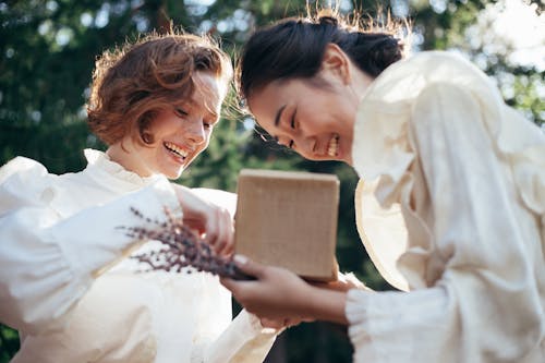 Free Smiling Women with Gift in Park Stock Photo