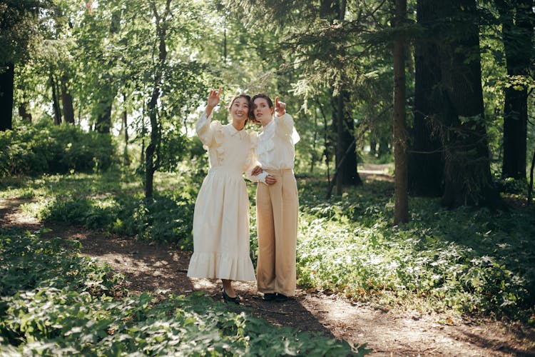 Women In The Forest Pointing Their Fingers 