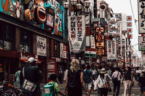 Free Vibrant shopping street in Osaka with people and colorful signs during day. Stock Photo