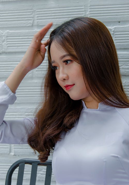 Photography of a Woman Touching Her Hair