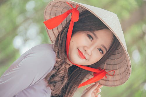 Free Close-Up Photography of a Woman Wearing Conical Hat Stock Photo