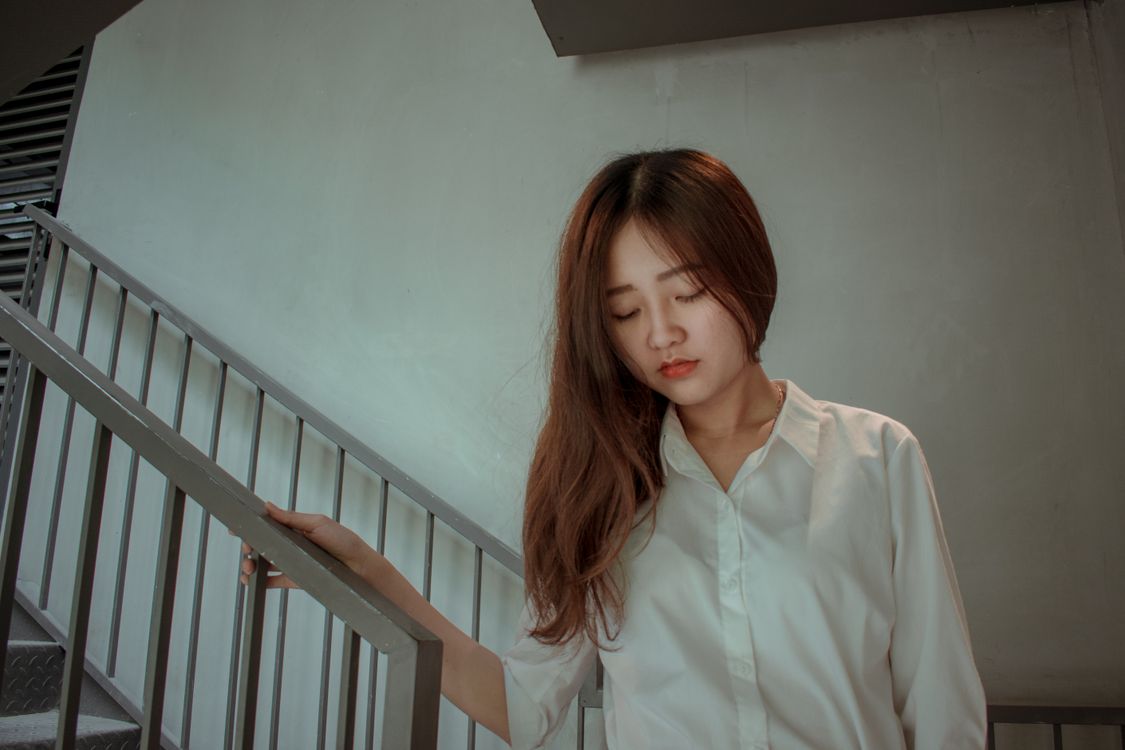Woman Using Handrail Photo of Woman Holding the Handrails · Free Stock Photo