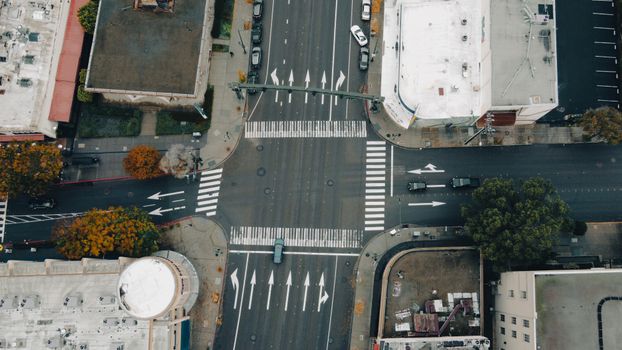 An aerial perspective capturing a busy urban intersection with vehicles and buildings.