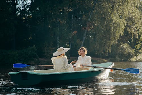 Two Women in 19th Century Outfits in Boat