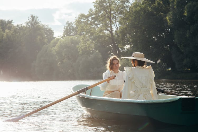Two Women In 19th Century Outfits In Boat