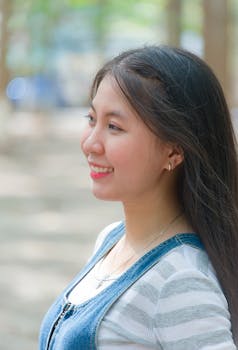 一位在户外阳光下微笑的女人的个人肖像，捕捉到了欢乐与放松