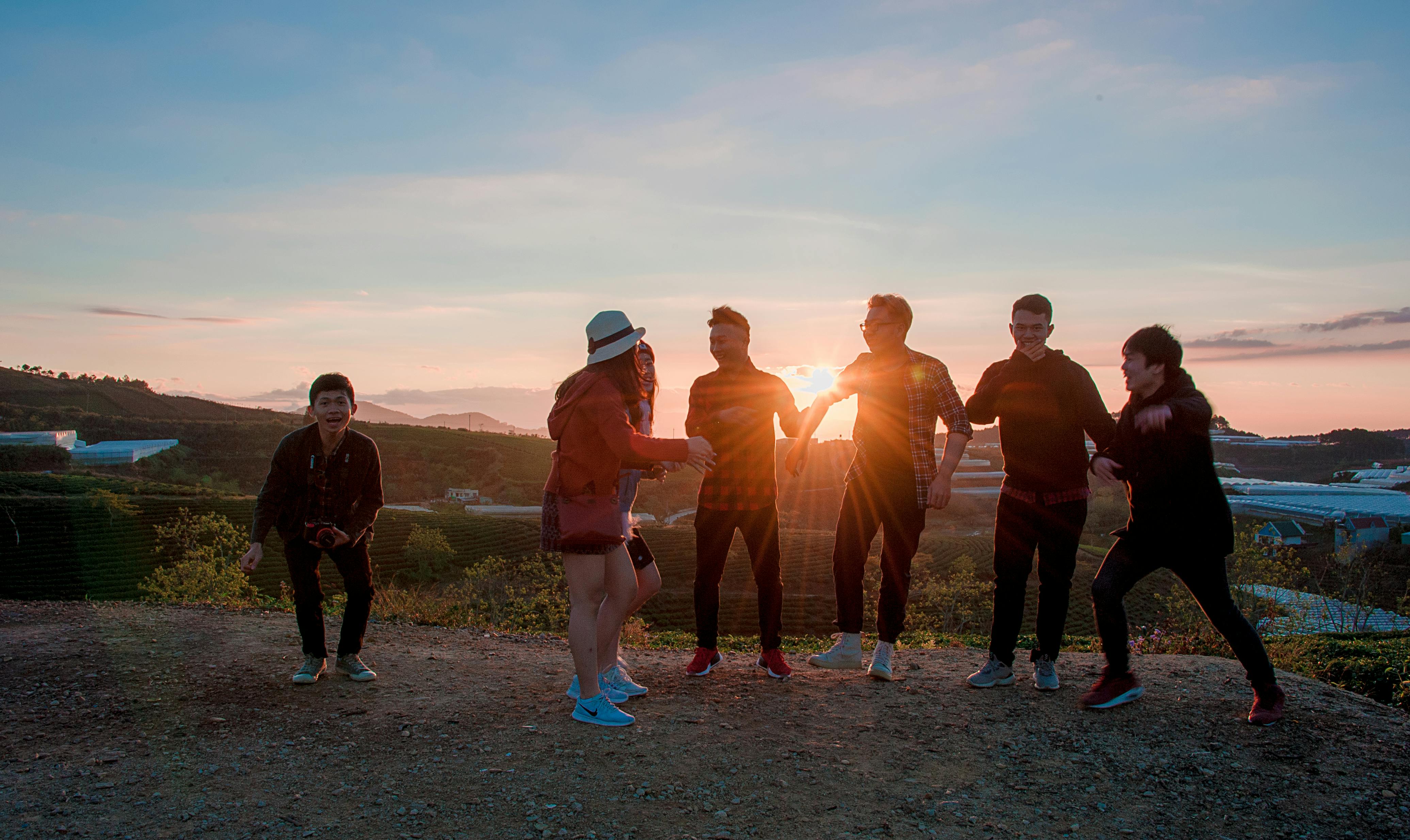 people gathering during sunset