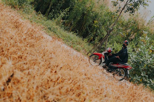 Man on White and Red Underbone Motorcycle