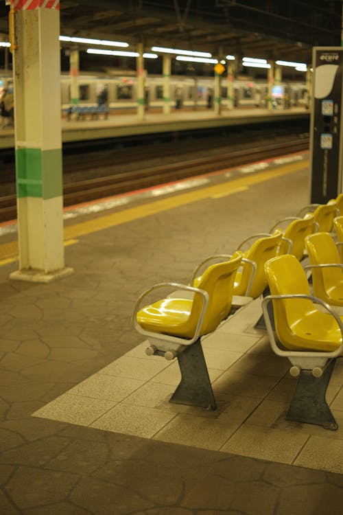 Free Yellow and White Gang Chairs in a Train Station Stock Photo
