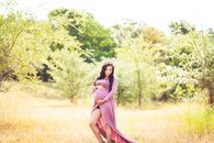 Woman Standing On Grass Field Surrounded With Trees