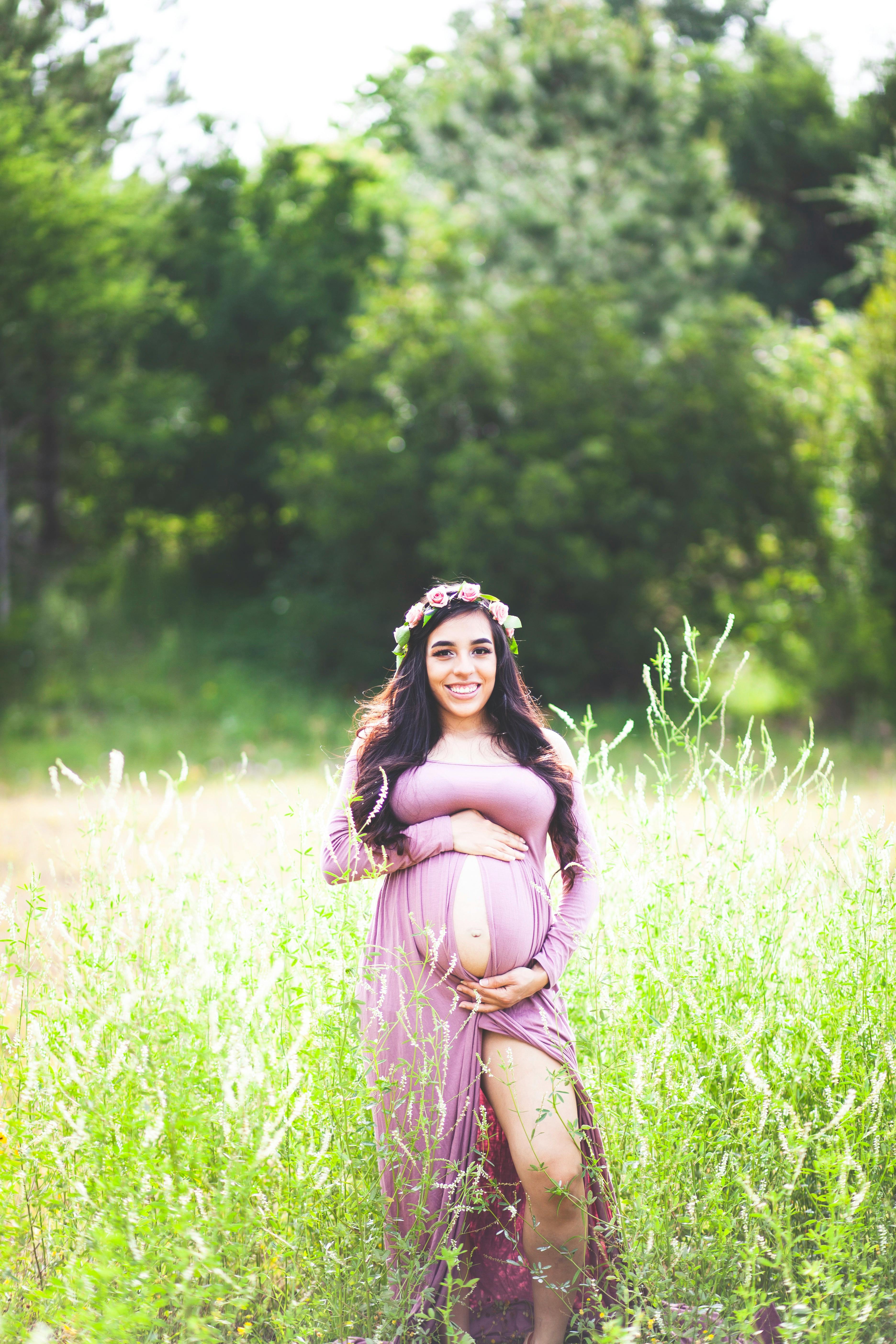 photography of pregnant woman on grass field