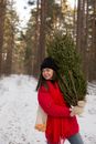 Woman in Red Coat Standing Near Green Pine Tree