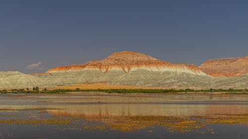 Fotos de stock gratuitas de arena, cielo azul, cuerpo de agua