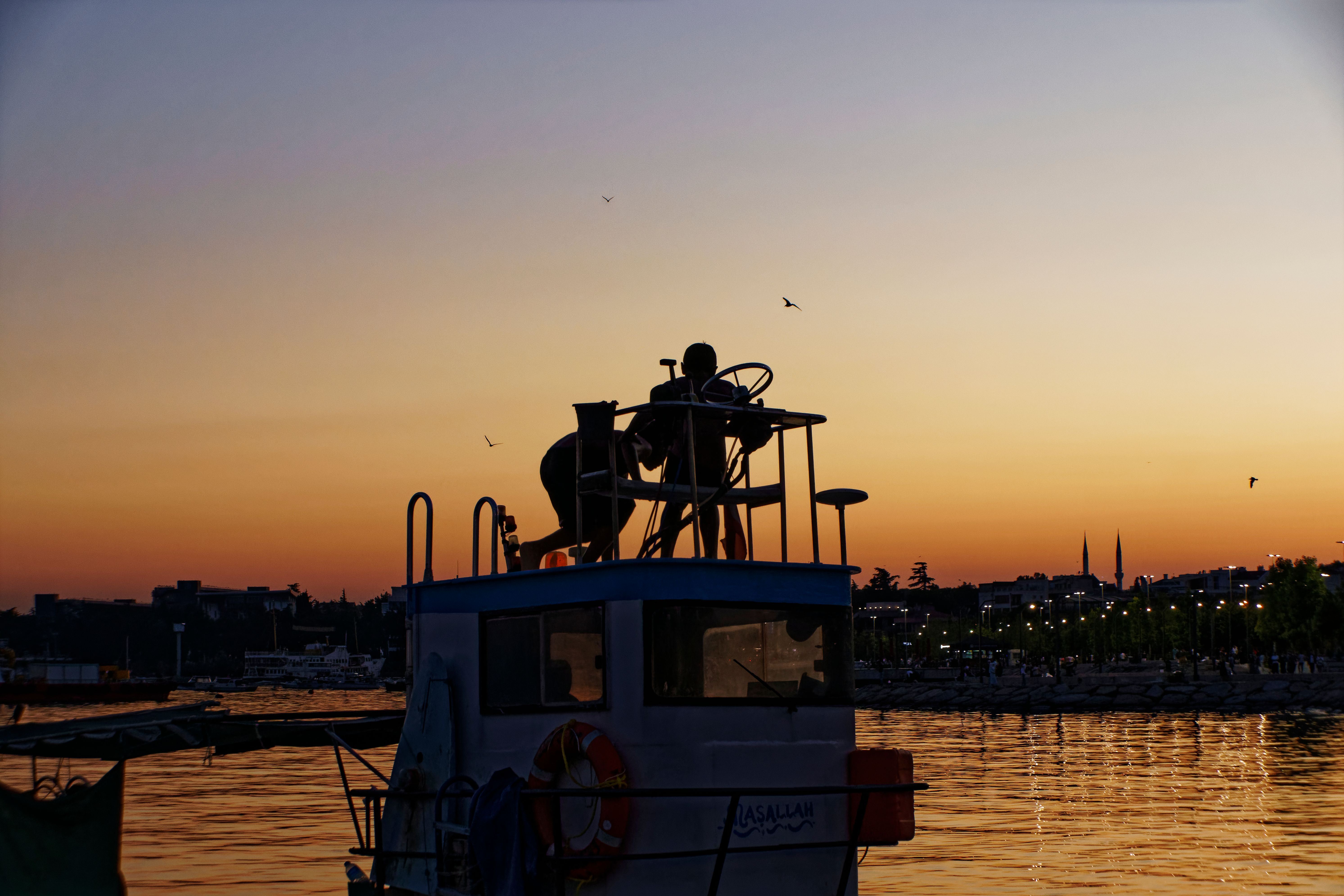 Silhouette of People Sitting on Top of the Boat During Sunset · Free ...