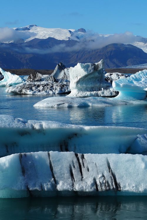 Free Stunning view of Iceland's glacial lagoon with floating icebergs under a clear sky. Stock Photo