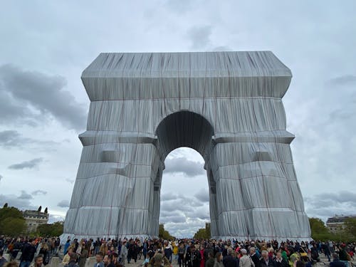 People Standing Near the Grey Concrete Arch