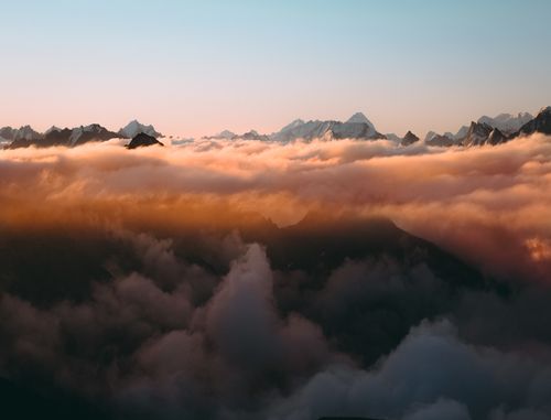 Free Beautiful sunrise over mountains with clouds creating a dreamlike landscape. Stock Photo