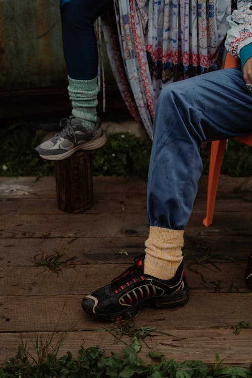 Person in Denim Pants Wearing Hiking Shoes