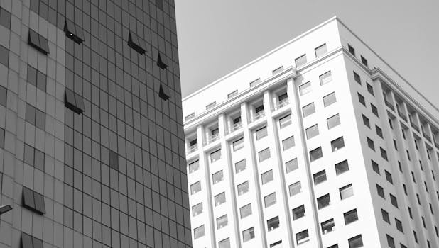 Black and white capture of modern skyscraper architecture with windows. Urban cityscape view.