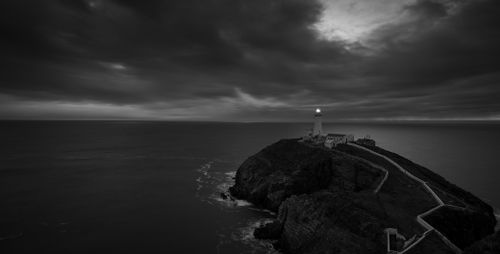 Free Stunning aerial view of South Stack Lighthouse, Wales, showcasing rugged cliffs and dark skies. Stock Photo