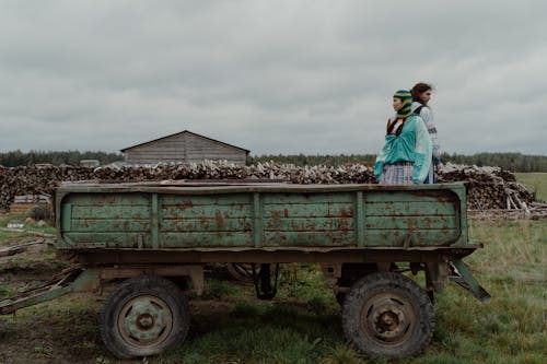 People Standing on Rusty Truck Wagon 