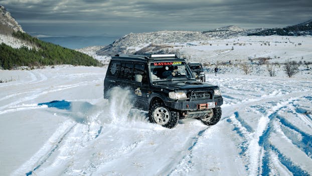 4x4 vehicle navigating snowy terrain in a winter adventure scene.