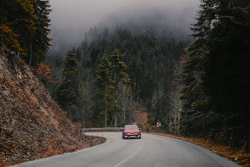 Orange Car on the Mountain Road 