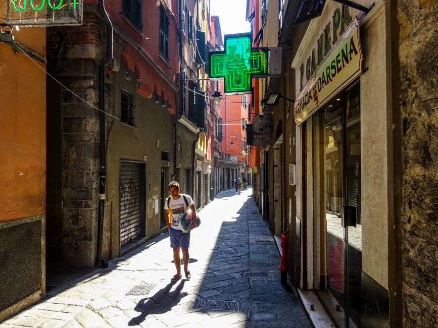 A traditional Greek pharmacy with a prominent green cross sign