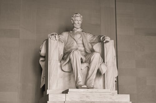 Free Man Sitting on Chair Statue Stock Photo