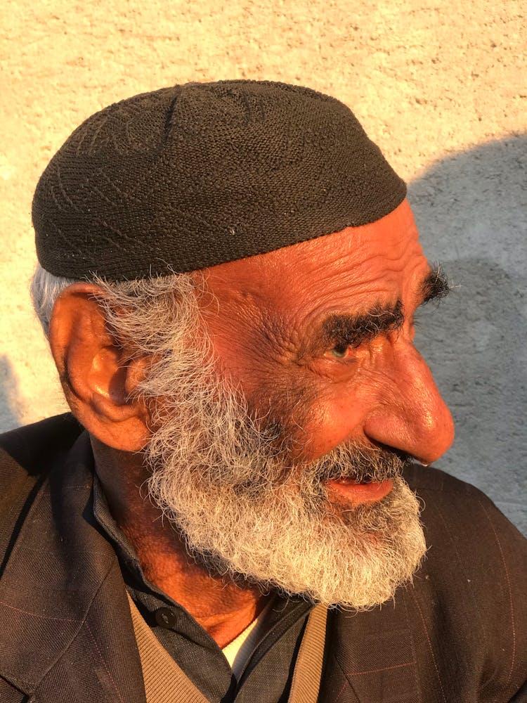 Elderly Man Wearing Knitted Kufi Cap 